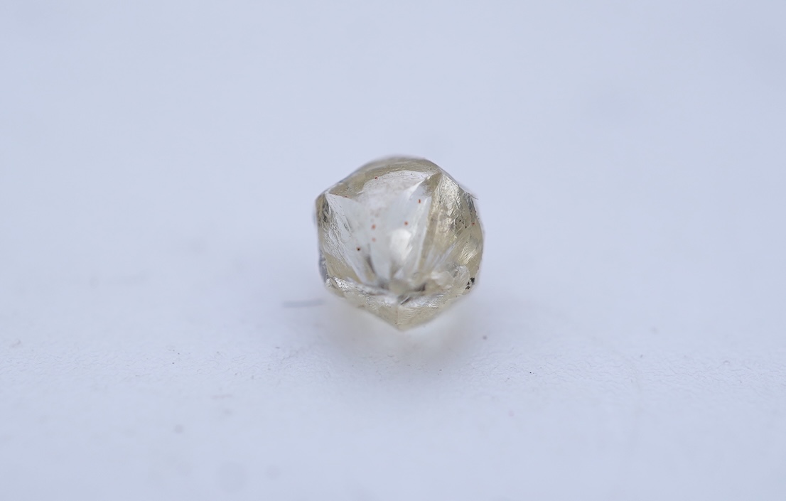 A rough diamond, with accompanying box and note, late 19th century